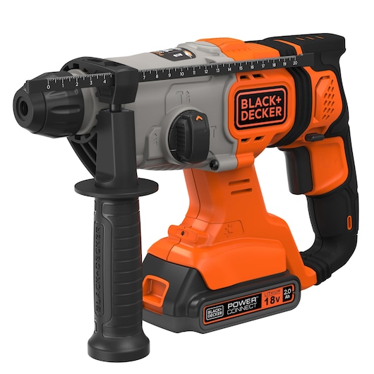 A BLACK+DECKER cordless rotary hammer drill with an 18V lithium battery. The tool is orange, black, and gray, features a side handle for stability, and has measurement markings along the top for precision drilling.