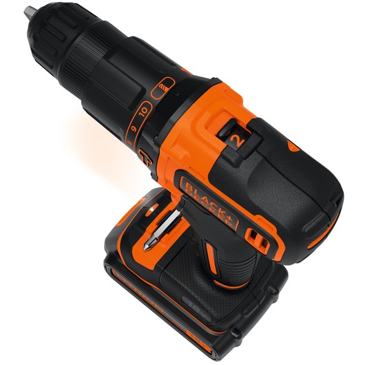 A close-up view of a BLACK+DECKER cordless power drill with orange and black detailing, showing the drill bit and battery pack.