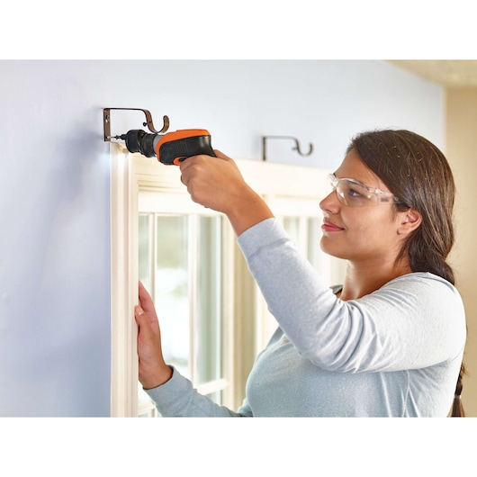 Photo of BLACKDECKER CSOA2 cordless screwdriver used to install curtain rod brackets indoors.
