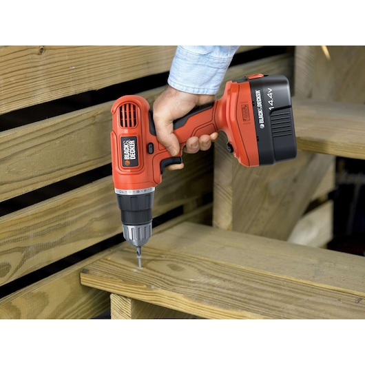 Photo of BLACKDECKER EPC14CA cordless drill in use on wooden stairs.
